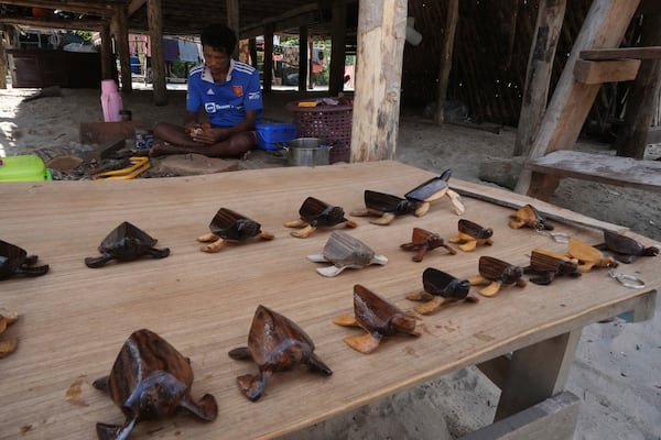 Pek Klathale makes handicraft for tourists to buy in Moken village at Surin Islands in Phang Nga Province, Thailand, Wednesday, Dec. 11, 2024. (AP Photo/Sakchai Lalit)