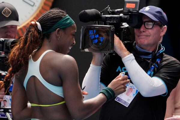 Coco Gauff of the U.S. writes "RIP Tik Tok USA" after defeating Belinda Bencic of Switzerland in a fourth round match at the Australian Open tennis championship in Melbourne, Australia, Sunday, Jan. 19, 2025. (AP Photo/Asanka Brendon Ratnayake)