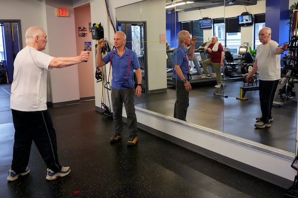 Dr. Grover Smith, left, works out with exercise scientist Dr. Irv Rubenstein, right, at STEPS Fitness, Wednesday, Feb. 12, 2025, in Nashville, Tenn. (AP Photo/George Walker IV)