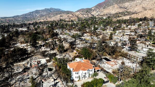 A lone home stands among residences levelled by the Eaton Fire in Altadena, Calif., on Tuesday, Jan. 21, 2025. (AP Photo/Noah Berger)