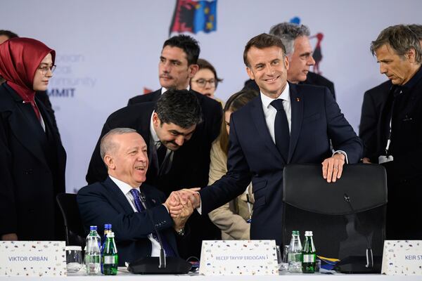 Turkish President Recep Tayyip Erdogan, left, talks with President of France Emmanuel Macron, right, ahead of a summit where the leaders of 47 European countries and organizations will discuss security, defense and democratic standards, in Tirana, Albania, Friday, May 16, 2025. (Leon Neal/Pool via AP)