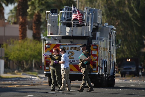 Investigators walk the on the scene of an explosion Saturday, May 17, 2025, in Palm Springs, Calif. (AP Photo/Eric Thayer)
