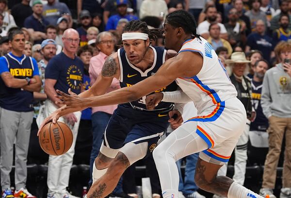 Denver Nuggets forward Aaron Gordon, left, drives past Oklahoma City Thunder forward Jalen Williams, right, in the first half of Game 4 in the Western Conference semifinals of the NBA basketball playoffs Sunday, May 11, 2025, in Denver. (AP Photo/David Zalubowski)