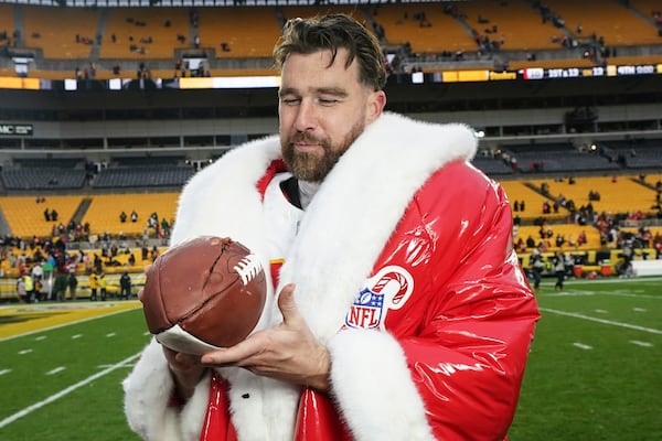 Kansas City Chiefs tight end Travis Kelce (87) holds a football after an NFL football game against the Pittsburgh Steelers, Wednesday, Dec. 25, 2024, in Pittsburgh. (AP Photo/Matt Freed)