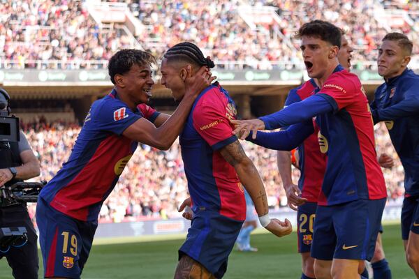 Barcelona's Raphinha, centre, celebrates with teammates after scoring his side's fourth goal during a Spanish La Liga soccer match between Barcelona and Celta de Vigo at the Lluis Companys Olympic stadium in Barcelona, Spain, Saturday, April 19, 2025. (AP Photo/Joan Monfort)