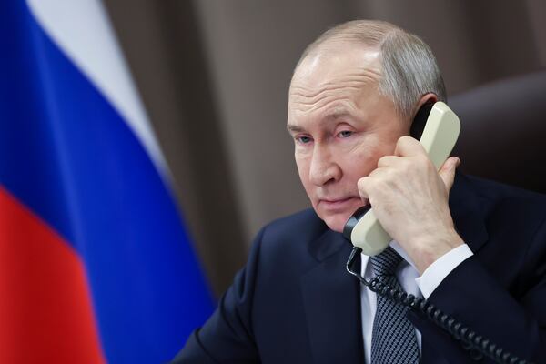 FILE - Russian President Vladimir Putin speaks on the phone with Taisia Leonova, a girl from the Moscow region, as part of a nationwide charity campaign fulfilling children's Christmas wishes in St. Petersburg, Russia, on Dec. 26, 2024. (Alexander Kazakov, Sputnik, Kremlin Pool Photo via AP, File)