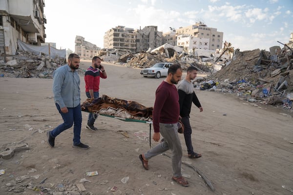 A body of a Palestinian killed in an Israeli army airstrikes is brought to Shifa Hospital in Gaza City, Tuesday, March 18, 2025. (AP Photo/Abdel Kareem Hana)