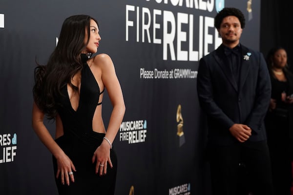 Olivia Rodrigo, left, and Trevor Noah arrive at the 67th annual Grammy Awards on Sunday, Feb. 2, 2025, in Los Angeles. (Photo by Jordan Strauss/Invision/AP)