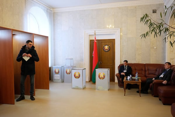 A man holds his ballot at a polling site during voting in the presidential election in Minsk, Belarus, Sunday, Jan. 26, 2025. (AP Photo/Pavel Bednyakov)