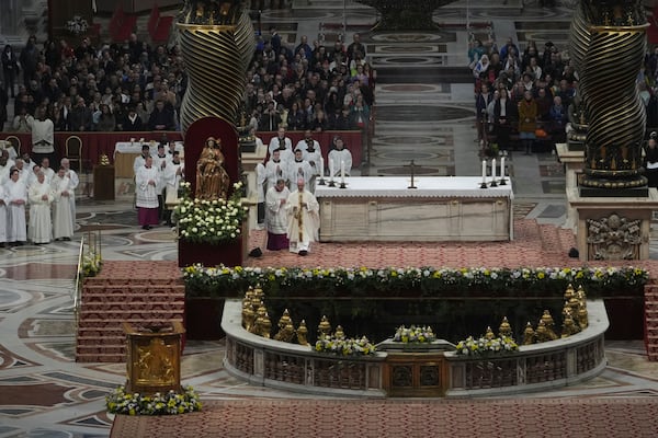 Archbishop Rino Fisichella, center, celebrates a mass for the jubilee of deacons Sunday, Feb. 23, 2025, in St. Peter's Basilica at The Vatican that was supposed to be presided over by Pope Francis who was admitted over a week ago at Rome's Agostino Gemelli Polyclinic and is in critical conditions. (AP Photo/Alessandra Tarantino)