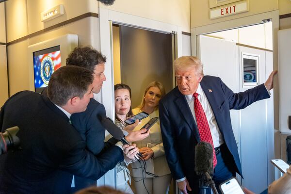 President Donald Trump speaks to reporters aboard Air Force One en route from Riyadh, Saudi Arabia to Doha, Qatar, Wednesday, May 14, 2025. (AP Photo/Alex Brandon)