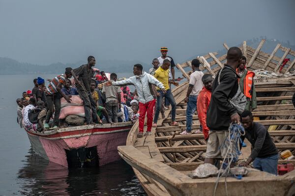 People fleeing M-23 rebel advances arrive by boat in Goma, Democratic Republic of the Congo, Wednesday, Jan. 22, 2025. (AP Photo/Moses Sawasawa)