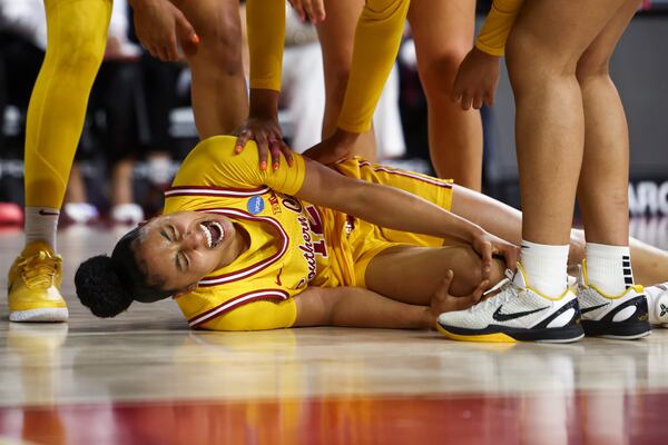 Southern California guard JuJu Watkins (12) reacts on the floor after an injury during the first half against Mississippi State in the second round of the NCAA college basketball tournament Monday, March 24, 2025, in Los Angeles. (AP Photo/Jessie Alcheh)