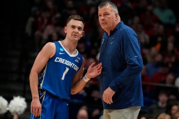 Creighton head coach Greg McDermott speaks with Steven Ashworth (1) during the first half in the first round of the NCAA college basketball tournament against Louisville, Thursday, March 20, 2025, in Lexington, Ky. (AP Photo/Brynn Anderson)