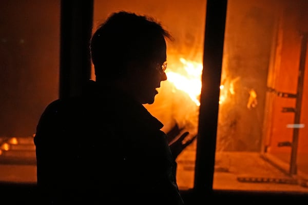 James Urban, assistant professor in the department of Fire Protection Engineering at Worcester Polytechnic Institute, watches a fire burn in a wind tunnel, Wednesday, Jan. 15, 2025, in Worcester, Mass. (AP Photo/Robert F. Bukaty)