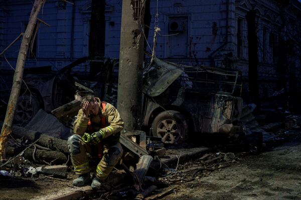FILE= A rescue worker rests near university building destroyed by a Russian missile strike on Sumy, Ukraine, April 13, 2025. (AP Photo/Evgeniy Maloletka, File)