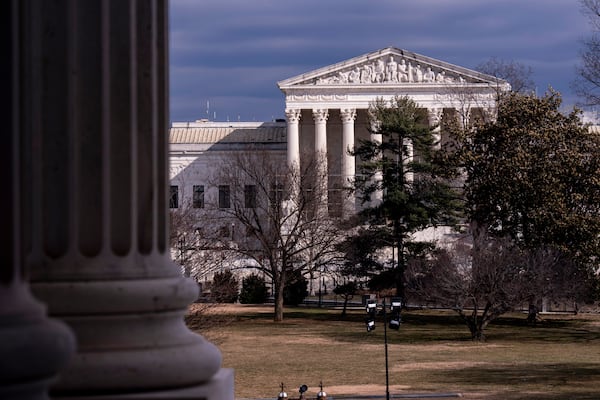 The Supreme Court is seen in the distance, framed through columns of the U.S. Senate at the Capitol in Washington, Thursday, Feb. 20, 2025. (AP Photo/J. Scott Applewhite)