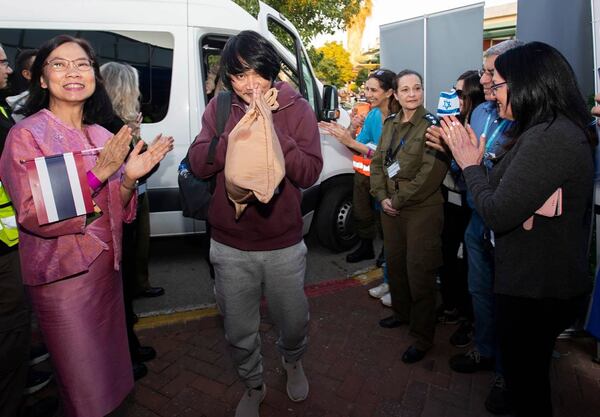 In this photo released by Royal Thai Embassy in Tel Aviv, Thai Ambassador to Israel Pannabha Chandraramya, left, welcomes Watchara Sriaoun, center, one of Thai hostages who were freed from Hamas, as he arrives in Israel, Thursday, Jan. 30, 2025. (Royal Thai Embassy in Tel Aviv via AP)