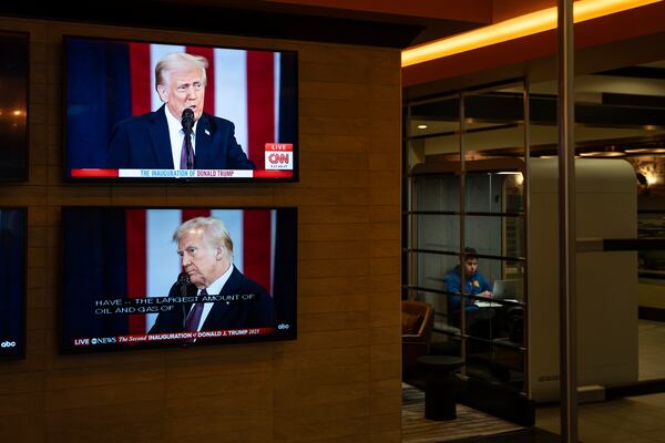 The inauguration of U.S. President Donald Trump plays live on screens in the lobby of a building in Halifax, Nova Scotia, on Monday, Jan. 20, 2025. (Darren Calabrese/The Canadian Press via AP)