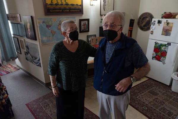 Joan Starr, left, looks at Al Hase as they stand in their apartment at Smith Tower Apartments on Monday, March 10, 2025, in Vancouver, Wash. (AP Photo/Jenny Kane)