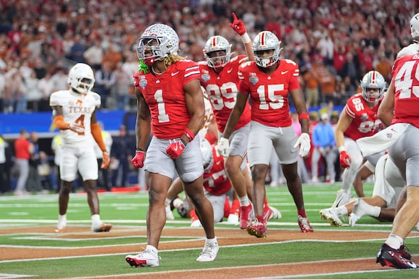 Ohio State running back Quinshon Judkins (1) reacts after scoring against Texas during the second half of the Cotton Bowl College Football Playoff semifinal game, Friday, Jan. 10, 2025, in Arlington, Texas. (AP Photo/Julio Cortez)