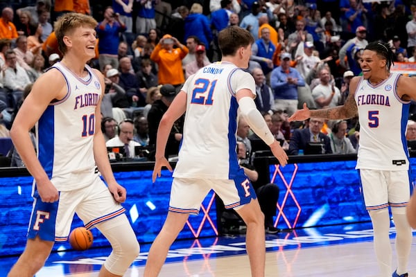 Florida players celebrate victory over Tennessee after an NCAA college basketball game in the final round of the Southeastern Conference tournament, Sunday, March 16, 2025, in Nashville, Tenn. (AP Photo/George Walker IV)