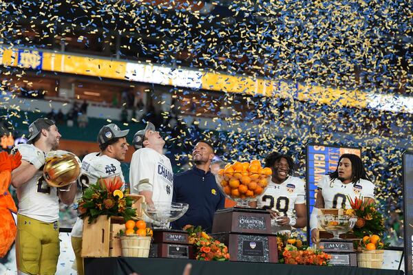 Notre Dame head coach Marcus Freeman, center, and members of the team celebrate after winning the Orange Bowl College Football Playoff semifinal game against Penn State, Thursday, Jan. 9, 2025, in Miami Gardens, Fla. (AP Photo/Rebecca Blackwell)