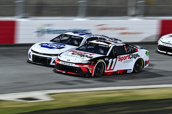 Denny Hamlin (11) and Chase Elliott (9) compete into Turn 1 during a NASCAR Cup Series auto race at Bowman Gray Stadium, Sunday, Feb. 2, 2025, in Winston-Salem, N.C. (AP Photo/Matt Kelley)