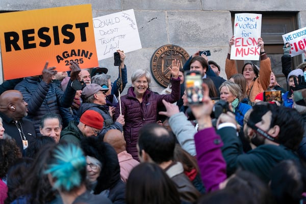 Sen. Elizabeth Warren, D-Mass., accompanied by other members of congress, speaks to the crowd during a rally against Elon Musk outside the Treasury Department in Washington, Tuesday, Feb. 4, 2025. (AP Photo/Jose Luis Magana)