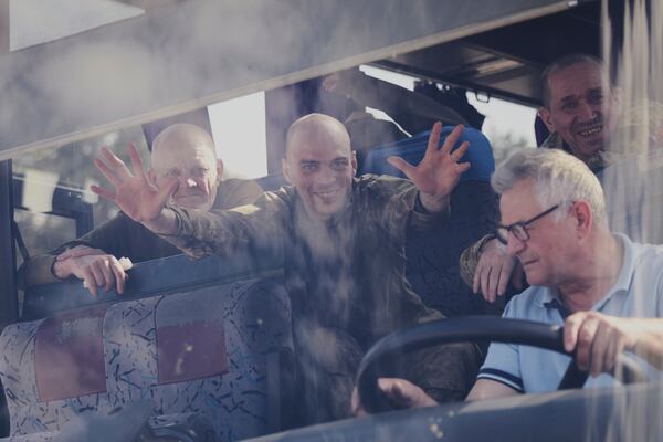 In this photo provided by the Ukrainian Presidential Press Office, Ukrainian servicemen ride in a bus after returning from captivity after an exchange between Russia and Ukraine, in Chernyhiv region, Ukraine, Friday, May 23, 2025. (Ukrainian Presidential Press Office via AP)