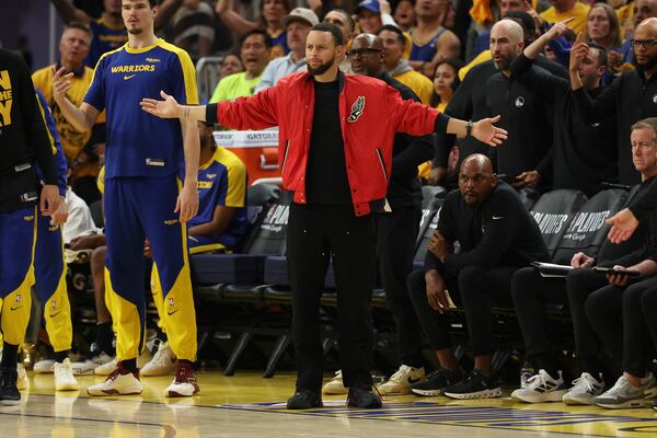Golden State Warriors guard Stephen Curry, center, reacts from the bench during the first half of Game 4 in the Western Conference semifinals of the NBA basketball playoffs against the Minnesota Timberwolves, Monday, May 12, 2025, in San Francisco. (AP Photo/Jed Jacobsohn)