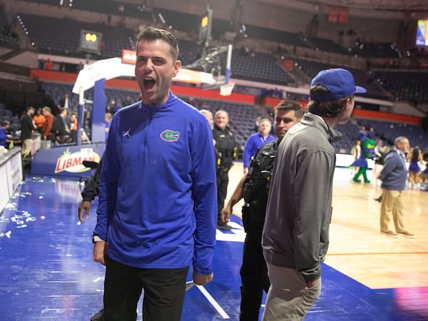 Florida head coach Todd Golden celebrates with fan after defeating Tennessee 73-43 in an NCAA college basketball game Tuesday, Jan. 7, 2025, in Gainesville, Fla. (AP Photo/Alan Youngblood)