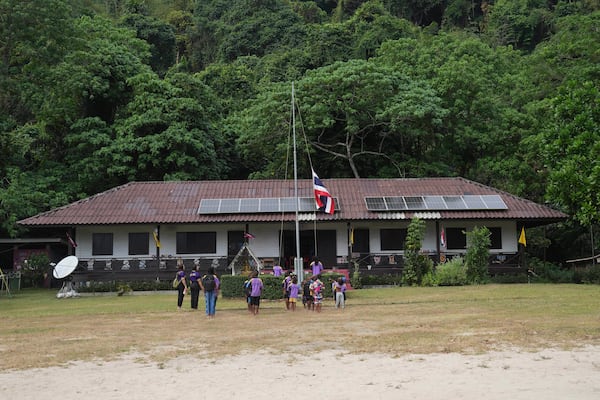 Moken students sing Thailand's national anthem at a learning center at Surin Islands in Phang Nga Province, Thailand, Thursday, Dec. 12, 2024. (AP Photo/Sakchai Lalit)