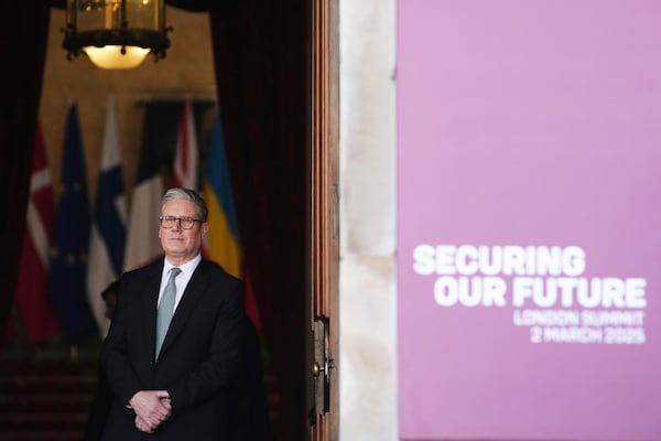 Britain's Prime Minister Keir Starmer waits in a doorway for arrivals during a summit on Ukraine at Lancaster House in London, Sunday, March 2, 2025. (AP Photo/Christophe Ena, Pool)