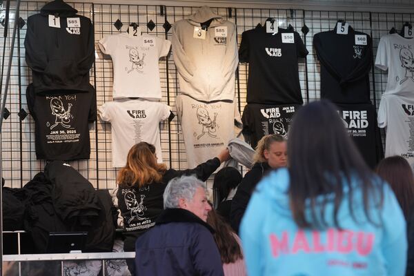 T-shirts promoting the FireAid benefit concert are seen on display on Thursday, Jan. 30, 2025, at The Forum in Inglewood, Calif. (AP Photo/Chris Pizzello)