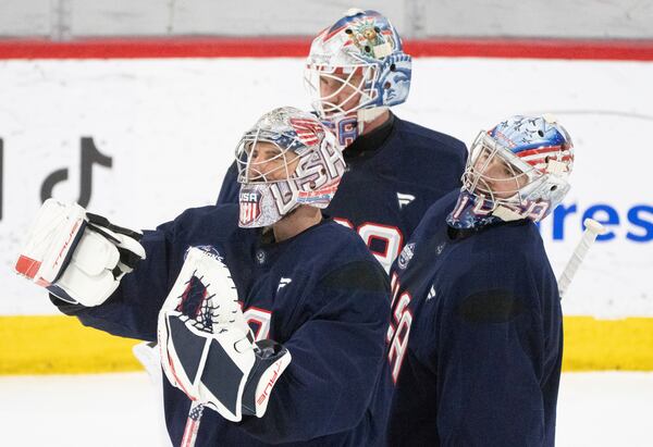 U.S. goaltenders from L-R Connor Hellebuyck, Jake Oettinger and Jeremy Swayman, on the ice during 4 Nations Face-Off hockey practice in Brossard, Que., on Monday, Feb. 10, 2025. (Christinne Muschi/The Canadian Press via AP)