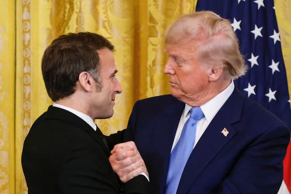 President Donald Trump, right, shakes the hand of France's President Emmanuel Macron during a joint press conference in the East Room of the White House in Washington, Monday, Feb. 24, 2025. (Ludovic Marin/Pool via AP)