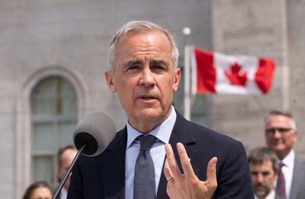 Canadian Prime Minister Mark Carney speaks to the media following a swearing-in ceremony at Rideau Hall in Ottawa, Ontario, Tuesday, May 13, 2025. (Christinne Muschi/The Canadian Press via AP)