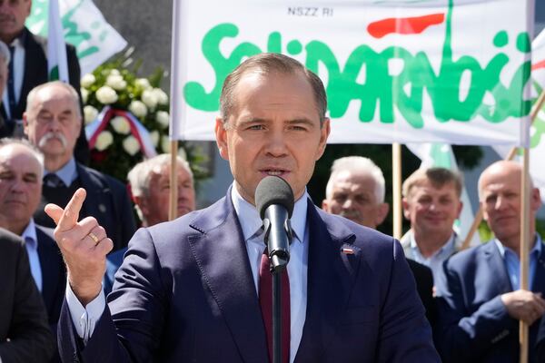 Karol Nawrocki, front, the conservative candidate heading into the second round of Poland's presidential election, meets with union members in Warsaw, Poland, on Tuesday, May 20, 2025. (AP Photo/Czarek Sokolowski)