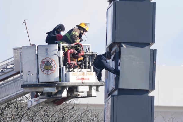 Investigators work the scene after a small plane crashed in Philadelphia, Saturday, Feb. 1, 2025. (AP Photo/Matt Rourke)