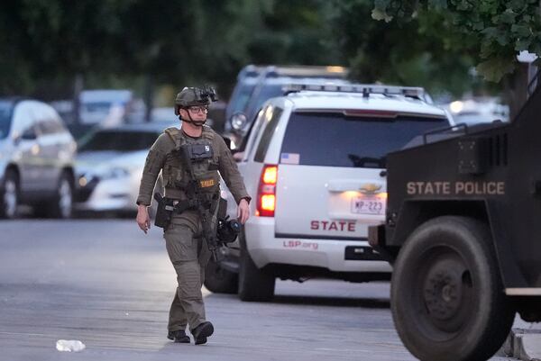 A Louisiana state police SWAT member works the scene on Iberville Street as police pursue a fugitive that escaped from a New Orleans jail, Tuesday, May 20, 2025, in New Orleans. (AP Photo/Gerald Herbert)