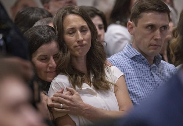 Jessica Brown, left, comforts Rivka Wilcoxson after Wilcoxson spoke about her family's loss during Chase Daniel Jones' sentencing on Friday, April 25, 2025, at the Maleng Regional Justice Center in Kent, Wash. Rivka's husband, Chace, is at right. (Ellen M. Banner/The Seattle Times via AP)