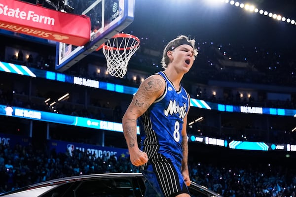 Orlando Magic guard Mac McClung celebrates after dunking over a car during the slam dunk contest at the NBA basketball All-Star Saturday night festivities Saturday, Feb. 15, 2025, in San Francisco. (AP Photo/Godofredo A. Vásquez)