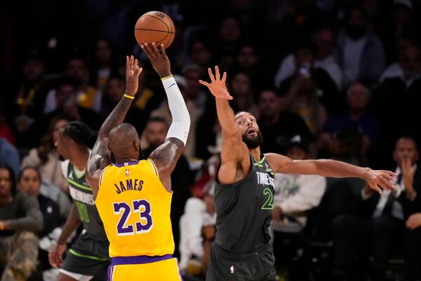 Los Angeles Lakers forward LeBron James (23) shoots over Minnesota Timberwolves center Rudy Gobert during the second half in Game 5 of an NBA basketball first-round playoff series Wednesday, April 30, 2025, in Los Angeles. (AP Photo/Mark J. Terrill)