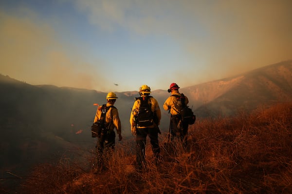 Firefighters look out over the Kenneth Fire, Thursday, Jan. 9, 2025, in the West Hills section of Los Angeles. (AP Photo/Eric Thayer)