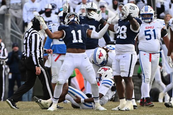 Penn State defensive end Abdul Carter (11) celebrates after sacking SMU quarterback Kevin Jennings during the second half in the first round of the NCAA College Football Playoff, Saturday, Dec. 21, 2024, in State College, Pa. (AP Photo/Barry Reeger)