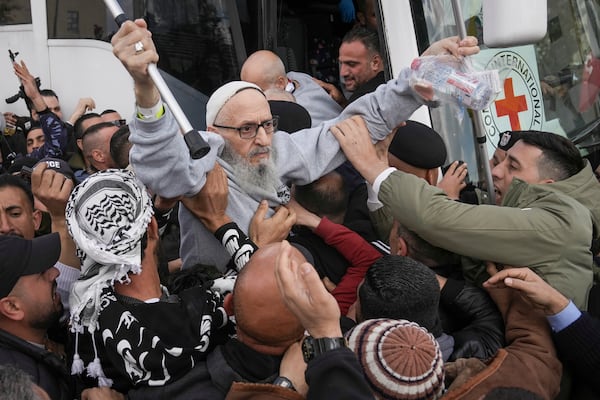 Palestinian prisoners as greeted as they exit a Red Cross bus after being released from Israeli prison following a ceasefire agreement between Israel and Hamas, in the West Bank city of Ramallah, Saturday Feb. 1, 2025. (AP Photo/Mahmoud Illean)