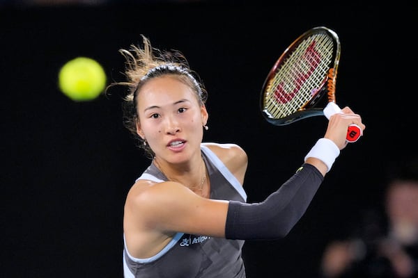 Zheng Qinwen of China plays a forehand return to Anca Todoni of Romania during their first round match at the Australian Open tennis championship in Melbourne, Australia, Sunday, Jan. 12, 2025. (AP Photo/Vincent Thian)