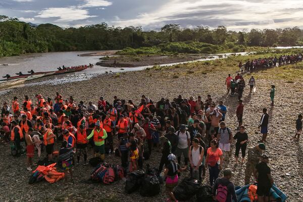 FILE - Migrants line up to board boats to continue their journey north hoping to reach the United States after walking across the Darien Gap from Colombia in Bajo Chiquito, Panama, Nov. 9, 2024. (AP Photo/Matias Delacroix, File)