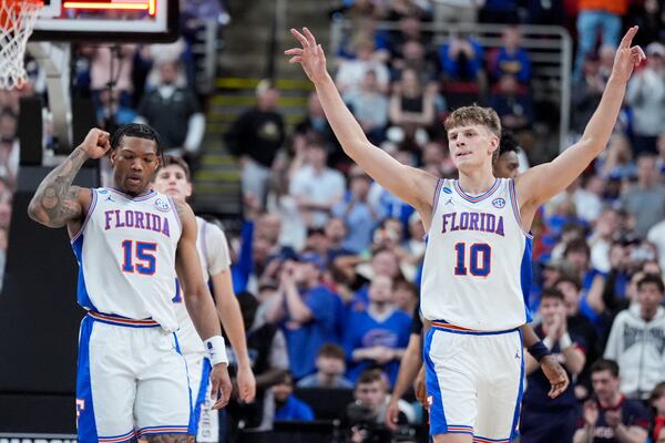 Florida forward Thomas Haugh (10) and guard Alijah Martin celebrates after their win against UConn in the second round of the NCAA college basketball tournament, Sunday, March 23, 2025, in Raleigh, N.C. (AP Photo/Chris Carlson)